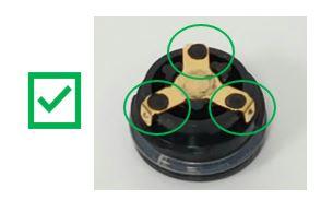 photo displaying an undamaged battery cap with three raised, round, black, plastic dots holding metal contact in place